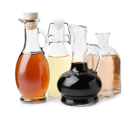 Different types of vinegar isolated on white
