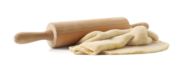 Raw dough and rolling pin isolated on white
