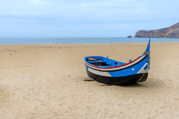 colorful fishing boat made of wood on the beach village Nazare, Portugal