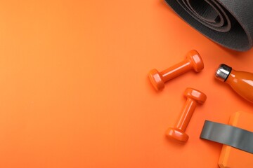 Dumbbells, yoga block, mat, thermo bottle and fitness elastic band on orange background, flat lay. Space for text