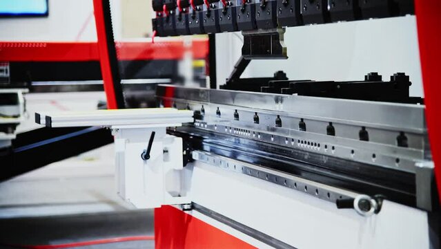 Pick and place industrial robotic arm manipulator moving sheet metal: part of hydraulic press bending machine