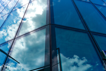 Looking up green glass facade of Prime Tower skyscraper with reflections of blue sky with clouds at Swiss City of Zürich on a sunny spring day. Photo taken May 25th, 2024, Zurich, Switzerland.