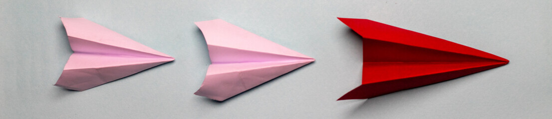 3 paper planes panorama on a dark grey background 