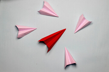 Business concept red plane with white paper planes on a light grey background motivation aviation...