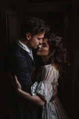 Dramatic portrait of a couple in a passionate embrace, dark background. Cover of a book about love, historical romance novel.