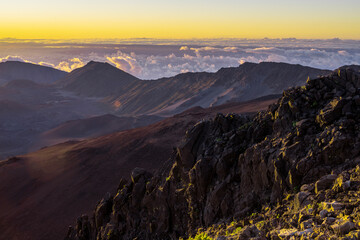 sunrise in the mountains Haleakala volcano national park Maui Hawaii with beautiful clouds layers over sky background USA