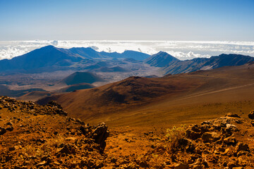 Beautiful Haleakala Volcano sunrise view from the top of the mountain with colorful hill layers over clouds sky background Maui Hawaii USA