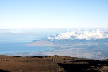 crater of volcano view above sky to the sea with clouds on top over sky background in Maui Hawaii USA.