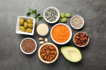 Different products high in natural fats on grey table, flat lay