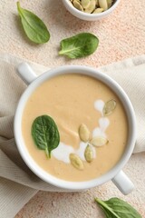 Healthy cream soup high in vegetable fats on color textured table, flat lay