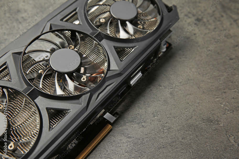 Fototapete one computer graphics card on grey textured table, closeup. space for text