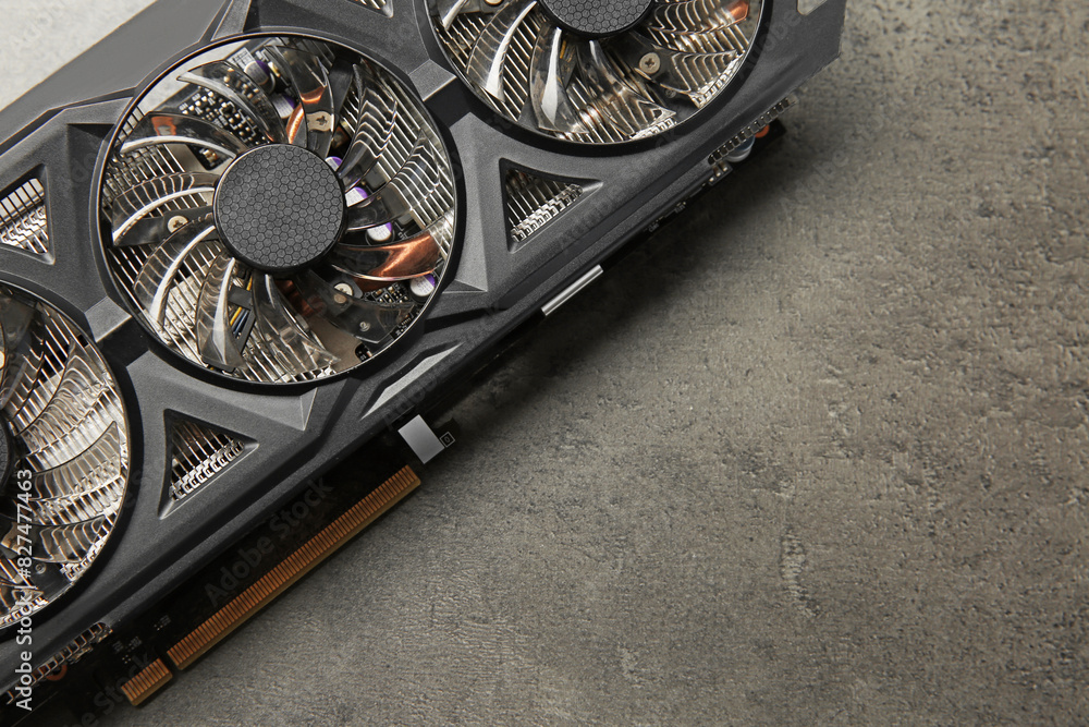 Fototapete one computer graphics card on grey textured table, top view. space for text