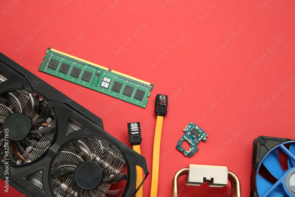 Fototapete graphics card and other computer hardware on red background, flat lay. space for text