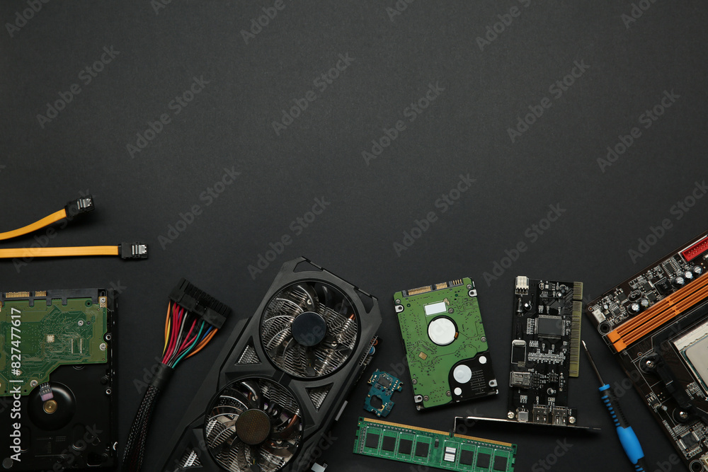 Fototapete graphics card and other computer hardware on black background, flat lay. space for text