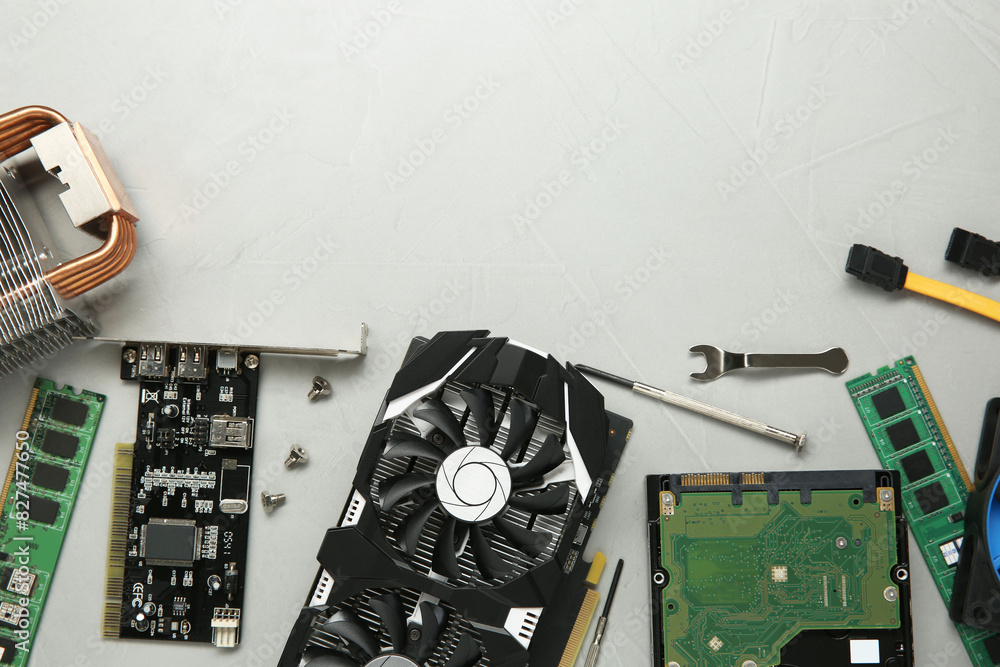 Fototapete graphics card and other computer hardware on gray textured background, flat lay. space for text