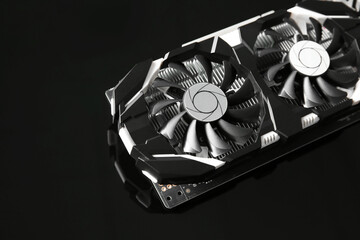 Computer graphics card on dark mirror surface, closeup