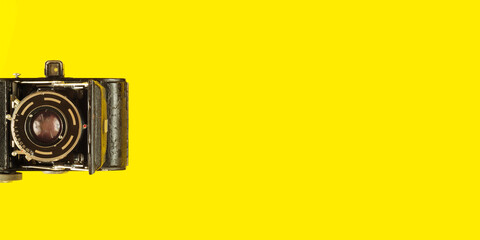 Comeback of film photography concept with vintage analog camera on yellow background,flat lay,negative space technique,free copy space