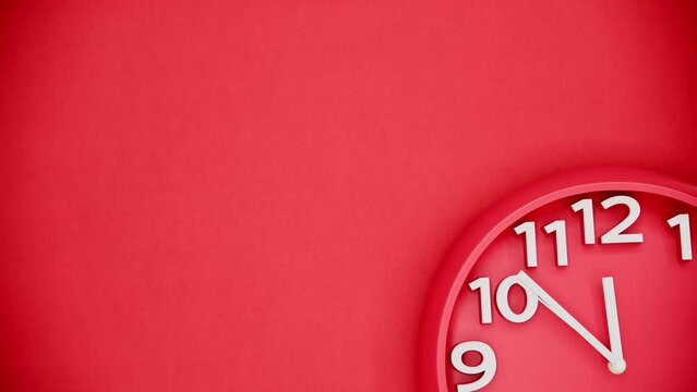 Time lapse of red clock hanging on red wall
