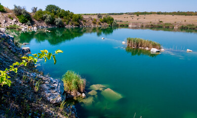 View of the flooded granite quarry with turquoise clear water