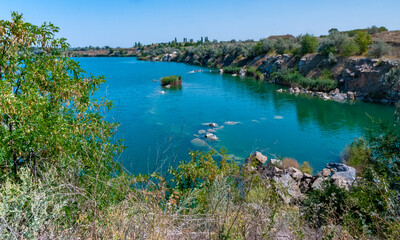 View of the flooded granite quarry with turquoise clear water, Ukraine