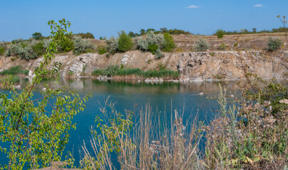 View of the flooded granite quarry with turquoise clear water, Ukraine