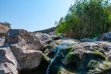 The stream flows down the granite stones on the riffles of the river, Ukraine