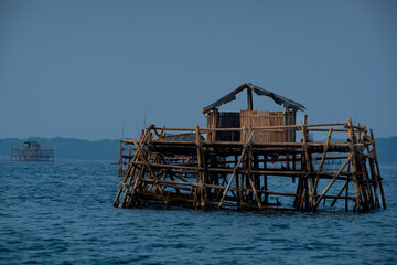 a floating bamboo fishermen's settlement over Jakarta Bay Indonesia, thousands islands or kepulauan...