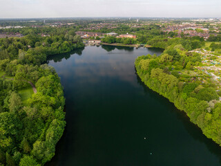 Aerial landscape image of Gorton Reservoir and Manchester cityscape on the horizon 