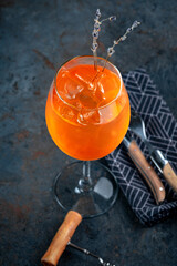 Aperol Spritz cocktail in a glass with ice, decorated with laven