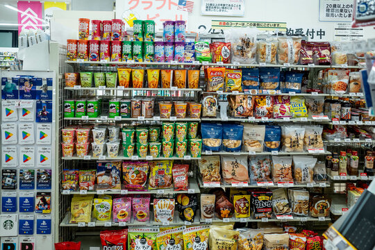 Shizuoka, Japan - November 10 2023 : Assorted snacks being  displayed on a rack inside a convenience store at Shizuoka City.