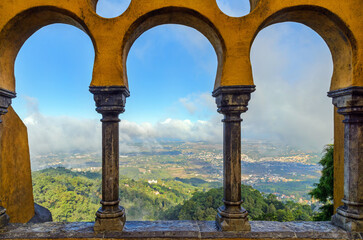 aerial view from Pena Palace to Sintra parish in fog and clouds, natural landscape of Sintra, Portugal