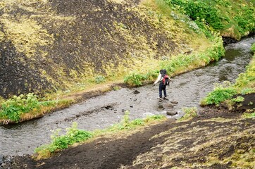Man crossing the river in Iceland