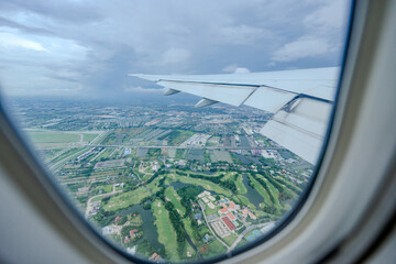 Gaze out of an airplane window to witness the harmonious blend of the airplane wing against the...