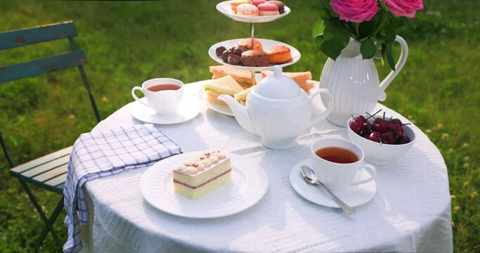 Traditional English afternoon tea on warm summer afternoon.