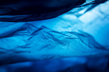 Extreme close up of blue empty plastic bag background.