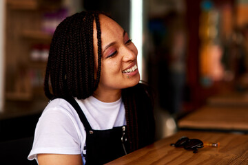 Coffee shop, happy and black woman in cafe at counter for drink, caffeine beverage and cappuccino....