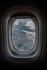 Aerial high-angle view from an airplane, show the sprawling suburbs of London in the United Kingdom, offering perspective of the city's extensive landscape.