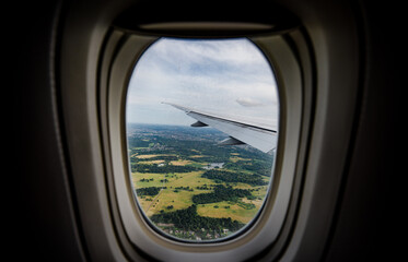 Fototapeta premium the serene beauty from an airplane window, featuring the wing silhouetted against an expansive, cloud-filled sky, instilling a sense of height and peacefulness.