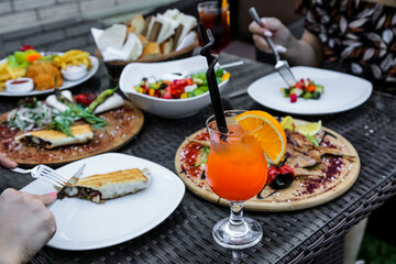 Table Adorned With Plates of Food and Drinks