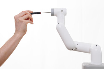 Close up on woman hand fixing a robot arm