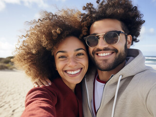 Biracial woman snaps a selfie as her boyfriend embraces her at the beach - Powered by Adobe