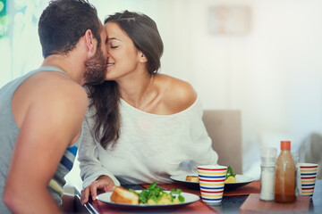 Breakfast, home and couple kiss with food, happy and love together with marriage at table. Hungry,...