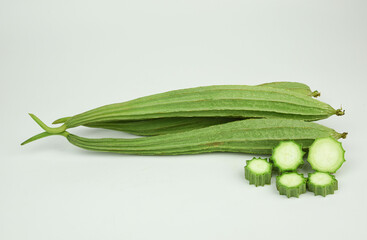 fresh square zucchini or  angled loofah  isolated on white back ground . organic vegetable  . angle luffa  