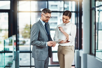 Mature, businessman and woman with tablet for feedback, guidance and planning project in office....