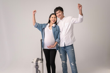Portrait of Beautiful pregnant woman and husband traveling over white background studio, insurance and maternity concept