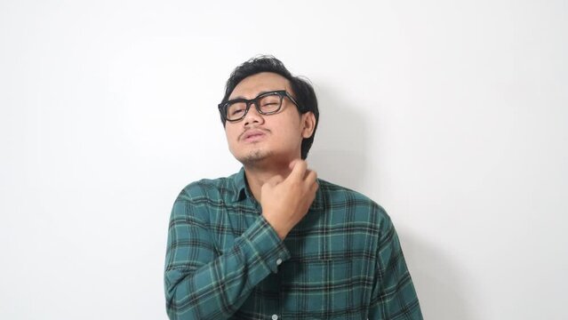 Adult Asian man scratching his neck and showing uncomfortable expression