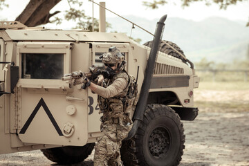 United States Army in camouflage uniforms operation in the forest.with armored vehicle, soldiers...