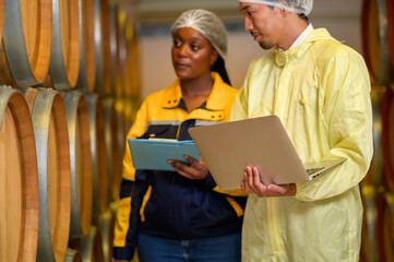 Professional winemaker controlling wine making process and quality at winery factory