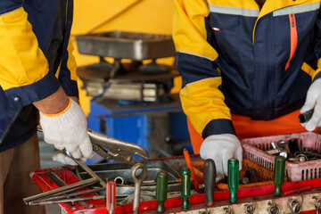 mechanics selecting tools from tool cart in garage. hands and tools, wearing white gloves....