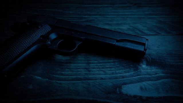 Gun Is Picked Up In Dark Room